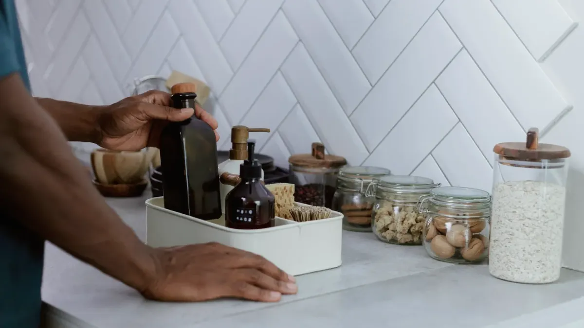 A dog owner holding two different supplement bottles side by side on a kitchen counter