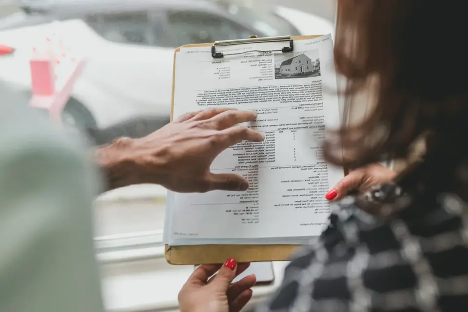 A veterinarian and a dog owner reviewing a medication list at a clinic counter