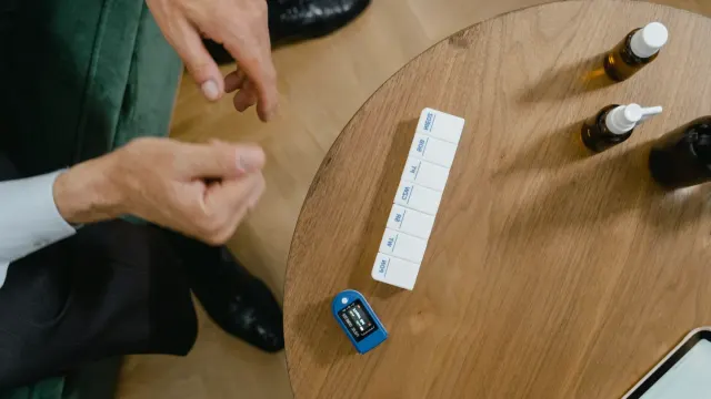 A veterinarian examines a row of supplement bottles next to a dog on an exam table