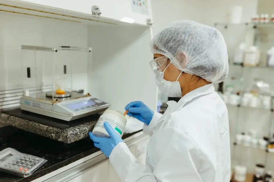 A veterinarian in an exam room reading the ingredient panel on a dog supplement bottle