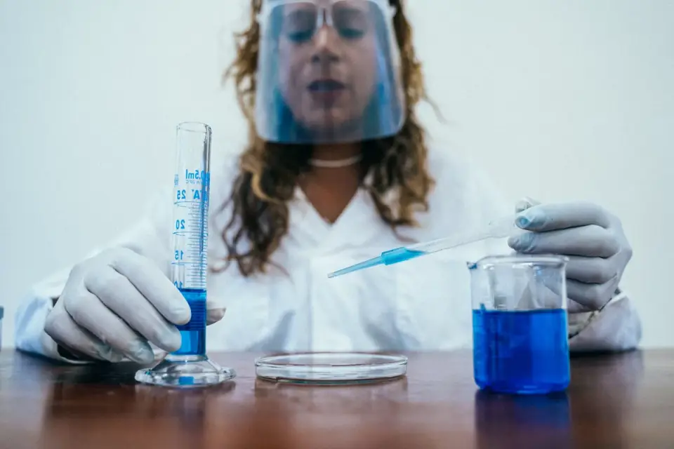A veterinarian measuring a precise liquid dose with a marked dropper for a small dog