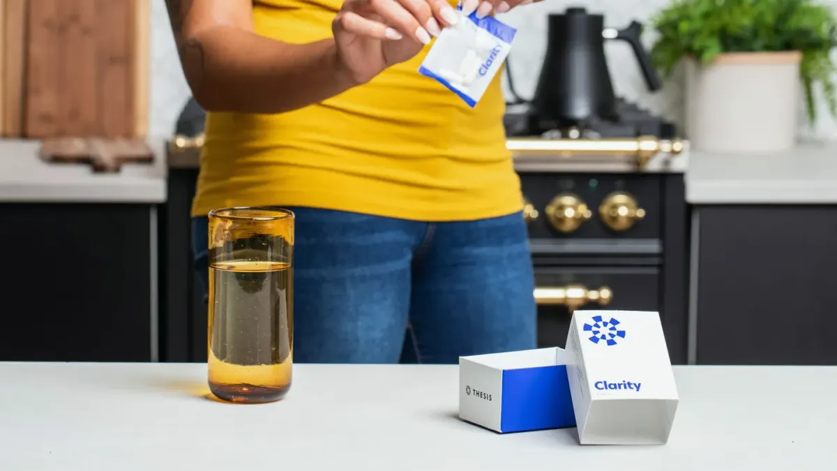 An owner comparing two dog supplement bottles side by side on a kitchen counter