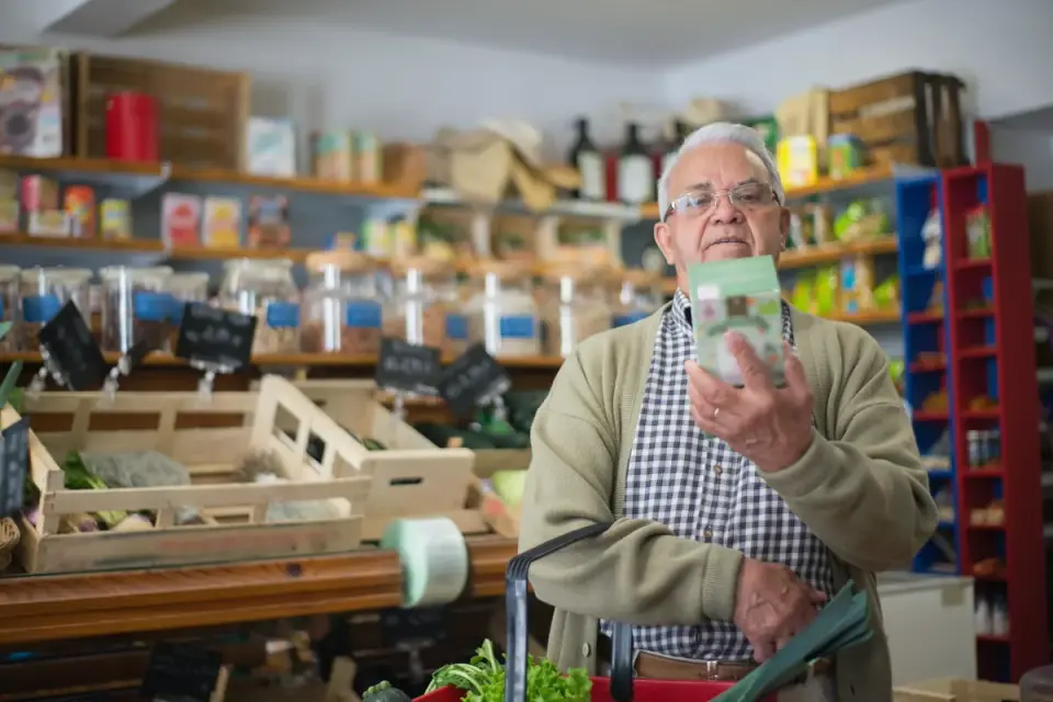 An owner reading the ingredient label on a dog supplement bottle