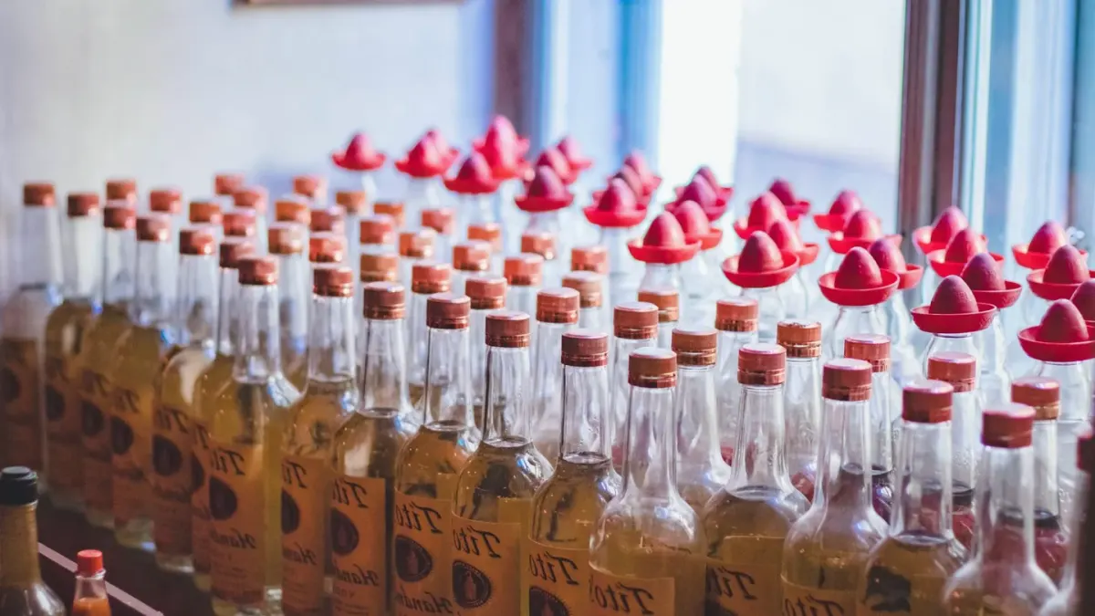 Multiple dog supplement bottles with different labels lined up on a shelf