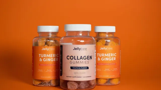 Two supplement bottles on a kitchen counter next to a dog waiting nearby